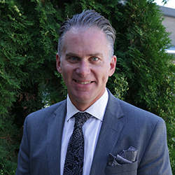 portrait photography of man wearing black suit jacket