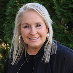 woman wearing gray denim jacket and black scarf