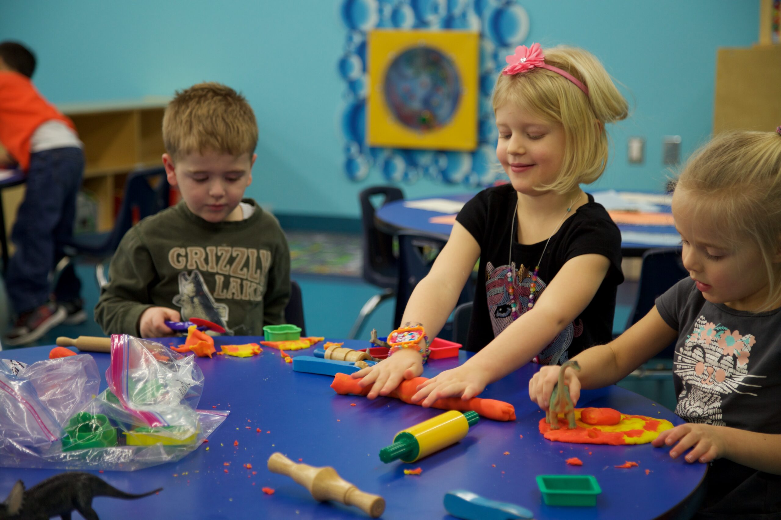 a child is drawing on a piece of paper